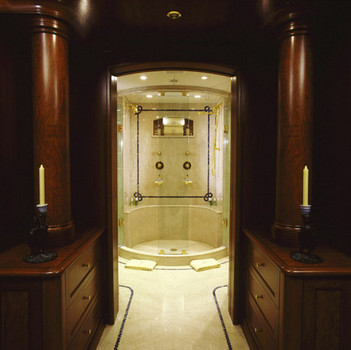 Bathroom entrance with custom wood columns and cabinets on either side of doorway.