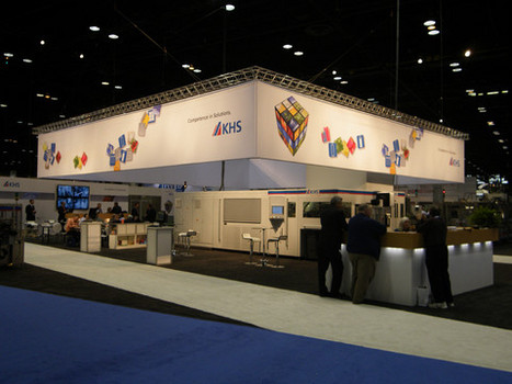 Custom exhibit displays at a trade show. Signs show KHS logo along with Rubix Cube and playful block design.