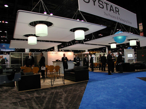 Custom lighting, seating area and hanging sign displays at a trade show for Oystar- The Process & Packaging Group
