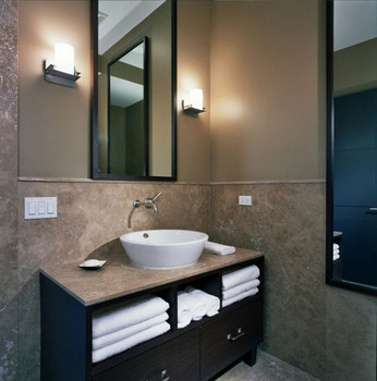 Bernard Woodwork in a custom bathroom. A pedestal sink above cabinets with towel shelves and additional storage.
